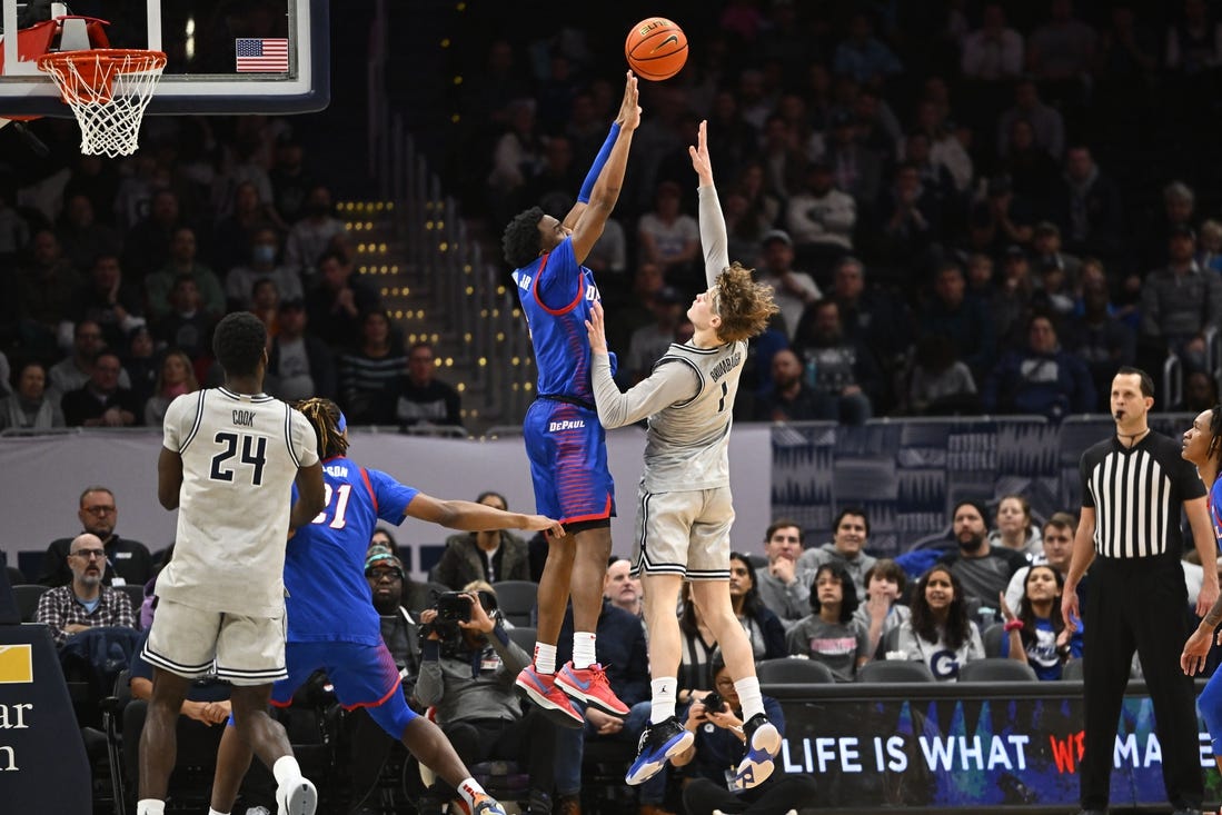 Jan 6, 2024; Washington, District of Columbia, USA; Georgetown Hoyas guard Rowan Brumbaugh (1) shoots over DePaul Blue Demons guard Chico Carter Jr. (2) during the second half at Capital One Arena. Mandatory Credit: Brad Mills-USA TODAY Sports