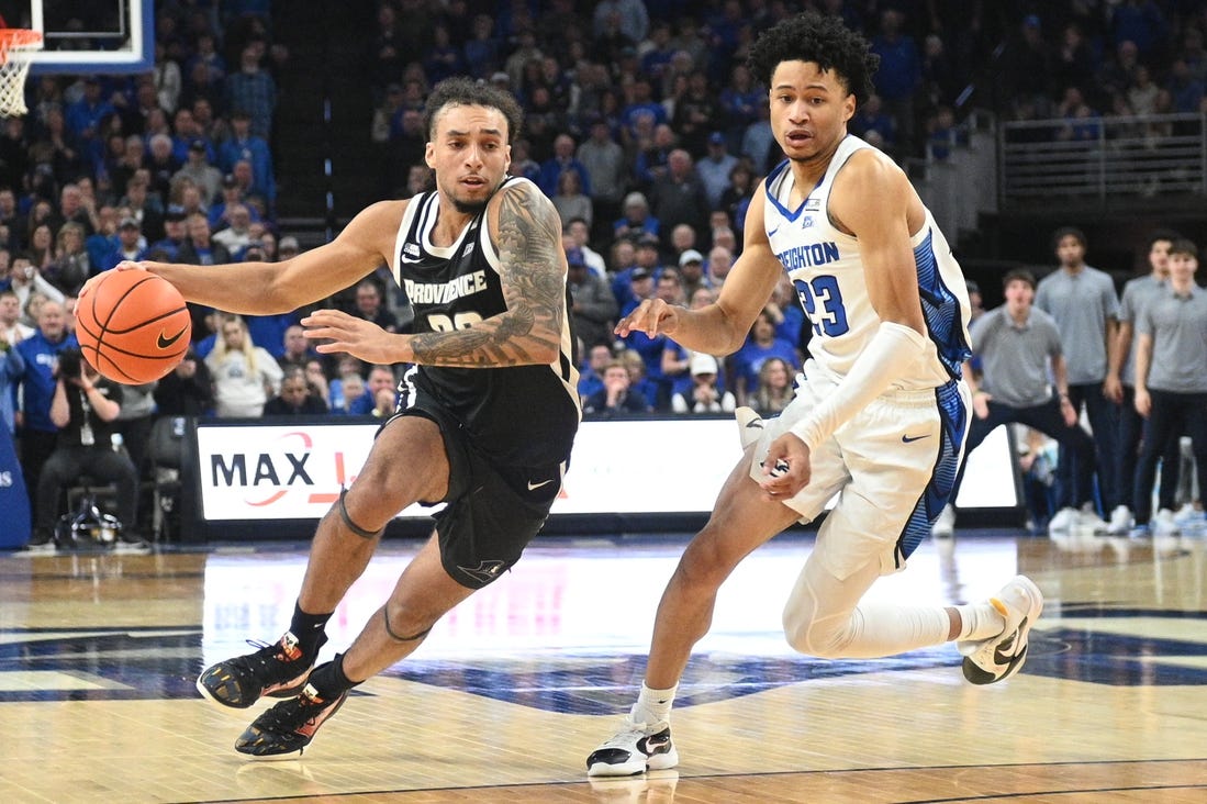 Jan 6, 2024; Omaha, Nebraska, USA; Providence Friars guard Devin Carter (22) drives against Creighton Bluejays guard Trey Alexander (23) in the second half at CHI Health Center Omaha. Mandatory Credit: Steven Branscombe-USA TODAY Sports