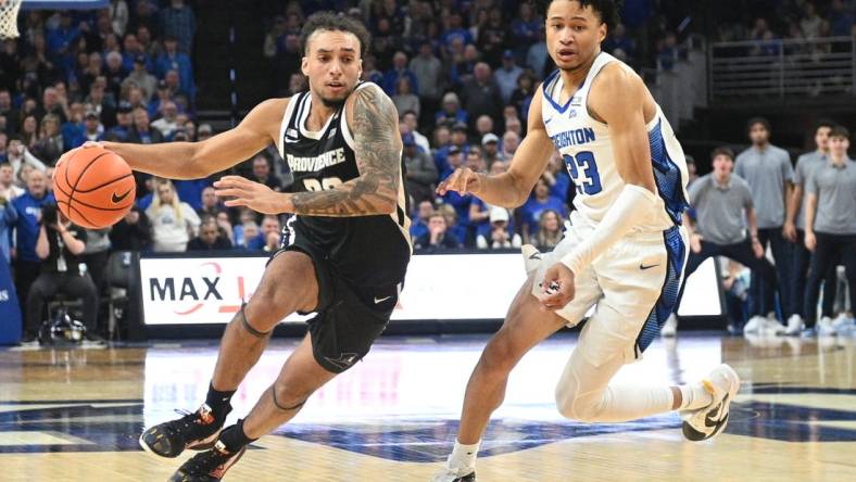 Jan 6, 2024; Omaha, Nebraska, USA; Providence Friars guard Devin Carter (22) drives against Creighton Bluejays guard Trey Alexander (23) in the second half at CHI Health Center Omaha. Mandatory Credit: Steven Branscombe-USA TODAY Sports