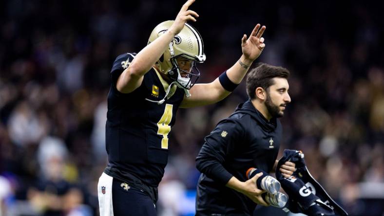 Jan 7, 2024; New Orleans, Louisiana, USA;  New Orleans Saints quarterback Derek Carr (4) reacts to a touchdown against the Atlanta Falcons during the first half at Caesars Superdome. Mandatory Credit: Stephen Lew-USA TODAY Sports