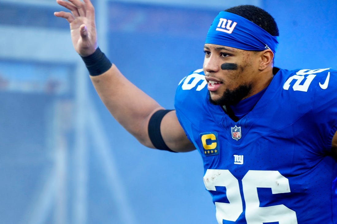 New York Giants running back Saquon Barkley (26) takes the field at MetLife Stadium, Sunday, January 7, 2024.