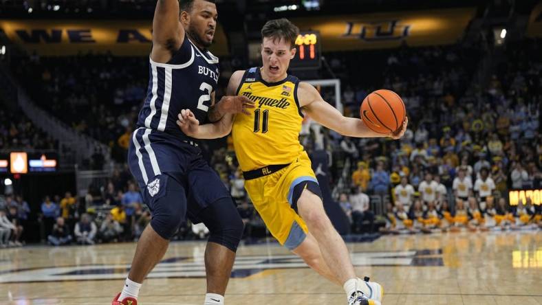 Jan 10, 2024; Milwaukee, Wisconsin, USA;  Marquette Golden Eagles guard Tyler Kolek (11) drives for the basket against Butler Bulldogs guard Pierre Brooks (21) during the second half at Fiserv Forum. Mandatory Credit: Jeff Hanisch-USA TODAY Sports