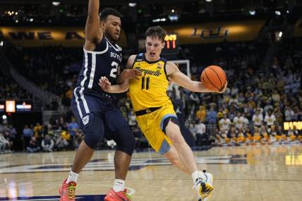 Jan 10, 2024; Milwaukee, Wisconsin, USA;  Marquette Golden Eagles guard Tyler Kolek (11) drives for the basket against Butler Bulldogs guard Pierre Brooks (21) during the second half at Fiserv Forum. Mandatory Credit: Jeff Hanisch-USA TODAY Sports