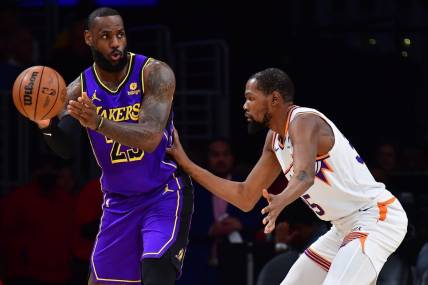 Jan 11, 2024; Los Angeles, California, USA; Los Angeles Lakers forward LeBron James (23) moves the ball against Phoenix Suns forward Kevin Durant (35) during the first half at Crypto.com Arena. Mandatory Credit: Gary A. Vasquez-USA TODAY Sports