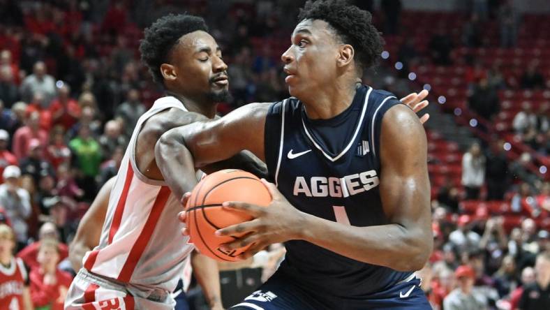 Jan 13, 2024; Las Vegas, Nevada, USA; Utah State Aggies forward Great Osobor (1) drives to the basket against UNLV Rebels forward Kalib Boone (10) in the second half at Thomas & Mack Center. Mandatory Credit: Candice Ward-USA TODAY Sports