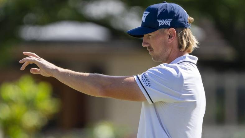 January 13, 2024; Honolulu, Hawaii, USA; Jake Knapp lines up his putt on the first hole during the third round of the Sony Open in Hawaii golf tournament at Waialae Country Club. Mandatory Credit: Kyle Terada-USA TODAY Sports