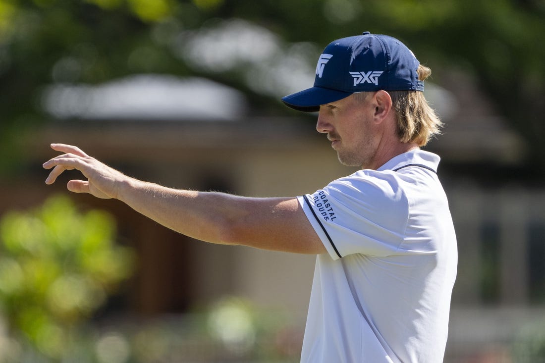 January 13, 2024; Honolulu, Hawaii, USA; Jake Knapp lines up his putt on the first hole during the third round of the Sony Open in Hawaii golf tournament at Waialae Country Club. Mandatory Credit: Kyle Terada-USA TODAY Sports