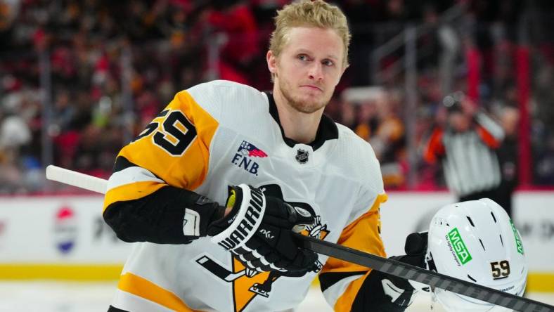 Jan 13, 2024; Raleigh, North Carolina, USA;  Pittsburgh Penguins left wing Jake Guentzel (59) looks on at the start of the game against the Carolina Hurricanes at PNC Arena. Mandatory Credit: James Guillory-USA TODAY Sports