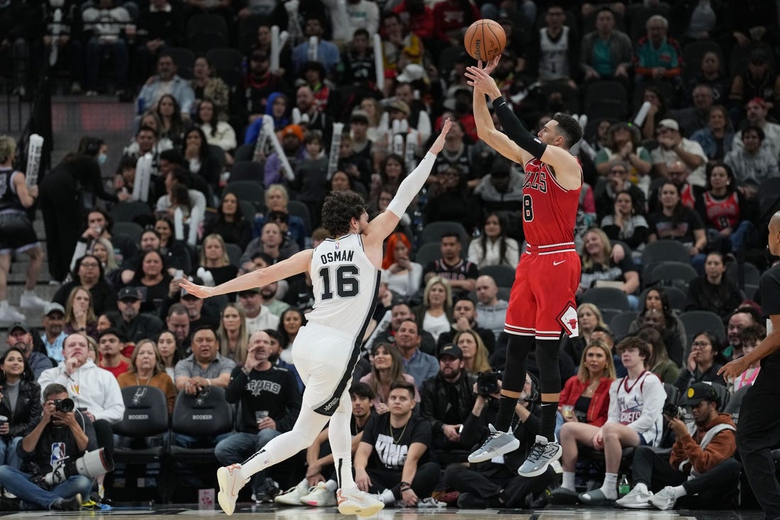 Jan 13, 2024; San Antonio, Texas, USA;  Chicago Bulls guard Zach LaVine (8) shoots over San Antonio Spurs forward Cedi Osman (16) in the second half at Frost Bank Center. Mandatory Credit: Daniel Dunn-USA TODAY Sports