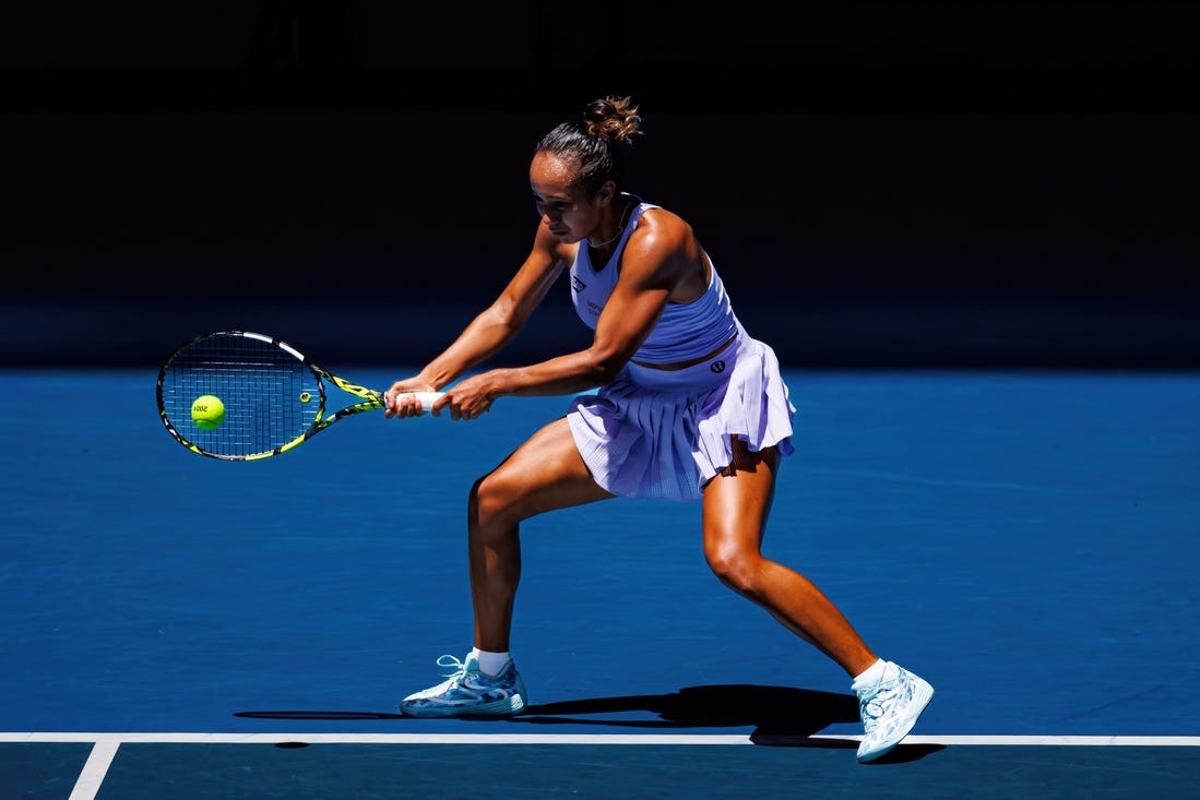 Jan 14, 2024; Melbourne, Victoria, Australia;  Leylah Fernandez of Canada hits a shot against Sarah Bejlek of the Czech Republic in the first round of the women s singles. Mandatory Credit: Mike Frey-USA TODAY Sports