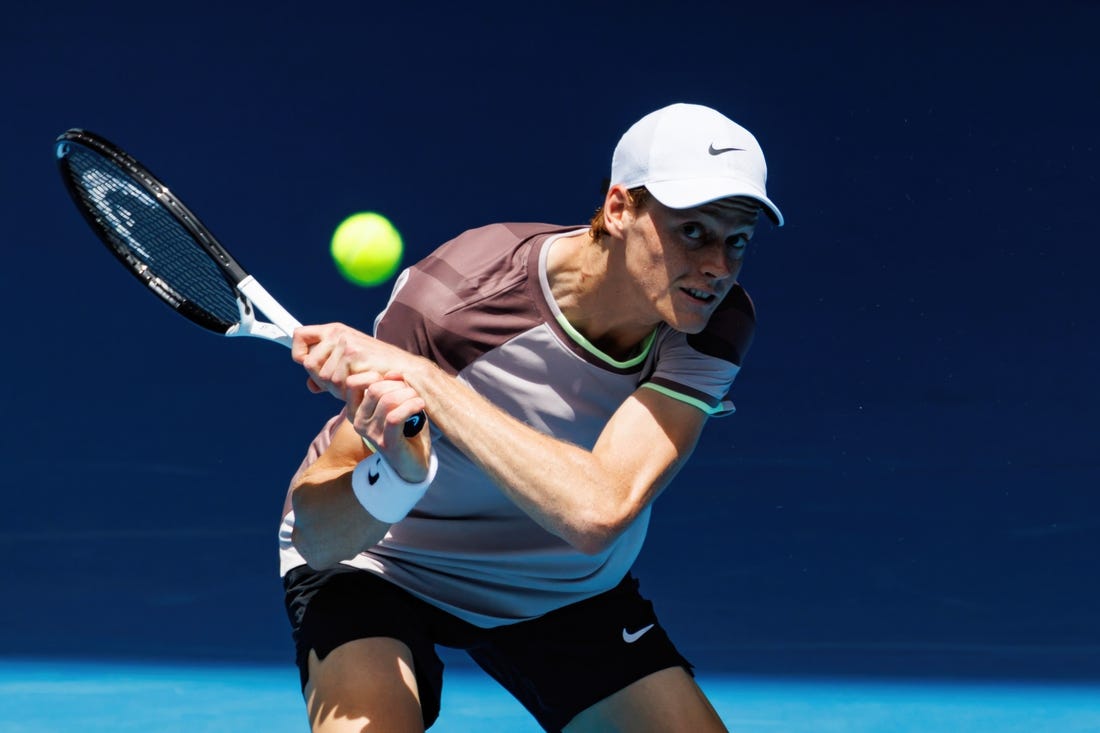 Jan 14, 2024; Melbourne, Victoria, Australia;   Jannik Sinner of Italy hits a shot against Botic Van De Zandschulp of the Netherlands in the first round of the men s singles. Mandatory Credit: Mike Frey-USA TODAY Sports