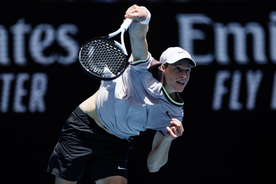 Jan 14, 2024; Melbourne, Victoria, Australia;   Jannik Sinner of Italy hits a shot against Botic Van De Zandschulp of the Netherlands in the first round of the men s singles. Mandatory Credit: Mike Frey-USA TODAY Sports