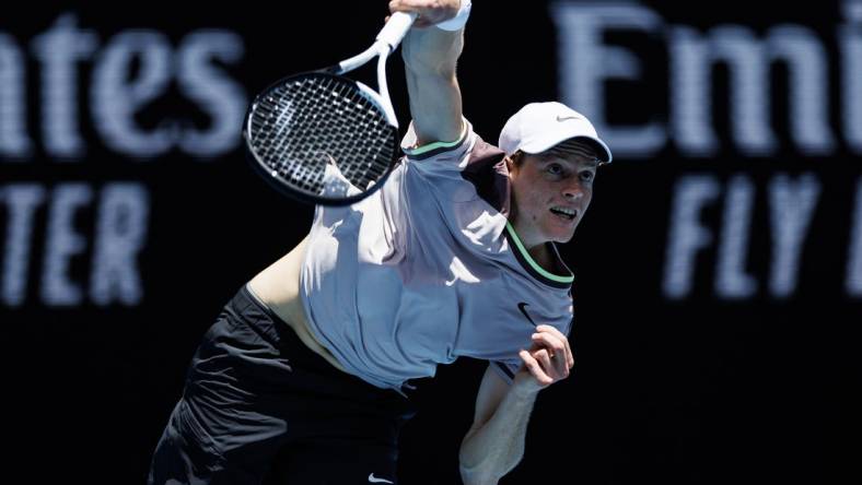 Jan 14, 2024; Melbourne, Victoria, Australia;   Jannik Sinner of Italy hits a shot against Botic Van De Zandschulp of the Netherlands in the first round of the men s singles. Mandatory Credit: Mike Frey-USA TODAY Sports