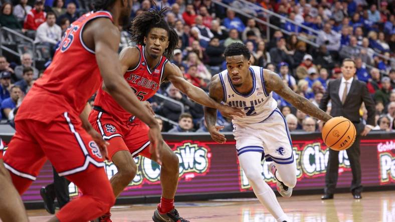 Jan 16, 2024; Newark, New Jersey, USA; Seton Hall Pirates guard Al-Amir Dawes (2) dribbles as St. John's Red Storm forward Glenn Taylor Jr. (35) and forward Drissa Traore (55) defend during the second half at Prudential Center. Mandatory Credit: Vincent Carchietta-USA TODAY Sports