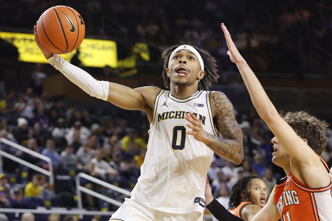 Jan 18, 2024; Ann Arbor, Michigan, USA;  Michigan Wolverines guard Dug McDaniel (0) shoots on Illinois Fighting Illini guard Niccolo Moretti (11) in the first half at Crisler Center. Mandatory Credit: Rick Osentoski-USA TODAY Sports