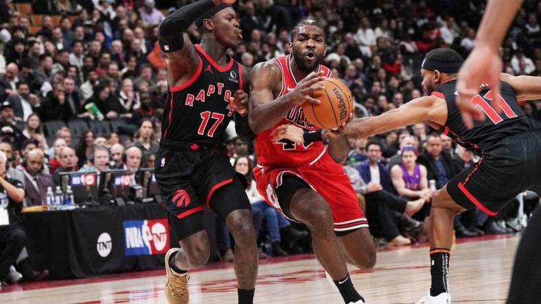 Jan 18, 2024; Toronto, Ontario, CAN; Chicago Bulls forward Patrick Williams (44) controls the ball between Toronto Raptors guard Dennis Schroder (17) and guard Bruce Brown (11) during the third quarter at Scotiabank Arena. Mandatory Credit: Nick Turchiaro-USA TODAY Sports