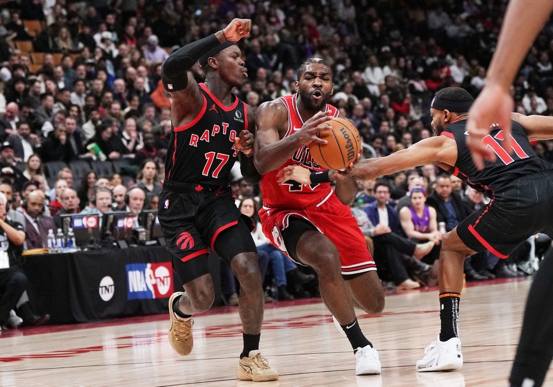 Jan 18, 2024; Toronto, Ontario, CAN; Chicago Bulls forward Patrick Williams (44) controls the ball between Toronto Raptors guard Dennis Schroder (17) and guard Bruce Brown (11) during the third quarter at Scotiabank Arena. Mandatory Credit: Nick Turchiaro-USA TODAY Sports