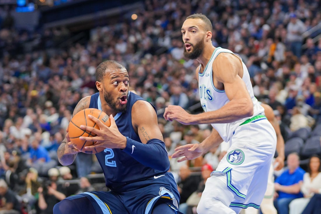 Jan 18, 2024; Minneapolis, Minnesota, USA; Memphis Grizzlies forward Xavier Tillman (2) drives against the Minnesota Timberwolves center Rudy Gobert (27) in the third quarter at Target Center. Mandatory Credit: Brad Rempel-USA TODAY Sports