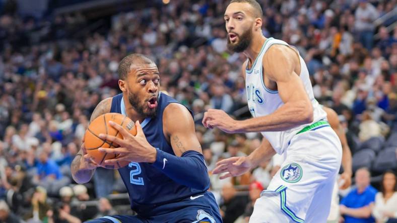 Jan 18, 2024; Minneapolis, Minnesota, USA; Memphis Grizzlies forward Xavier Tillman (2) drives against the Minnesota Timberwolves center Rudy Gobert (27) in the third quarter at Target Center. Mandatory Credit: Brad Rempel-USA TODAY Sports