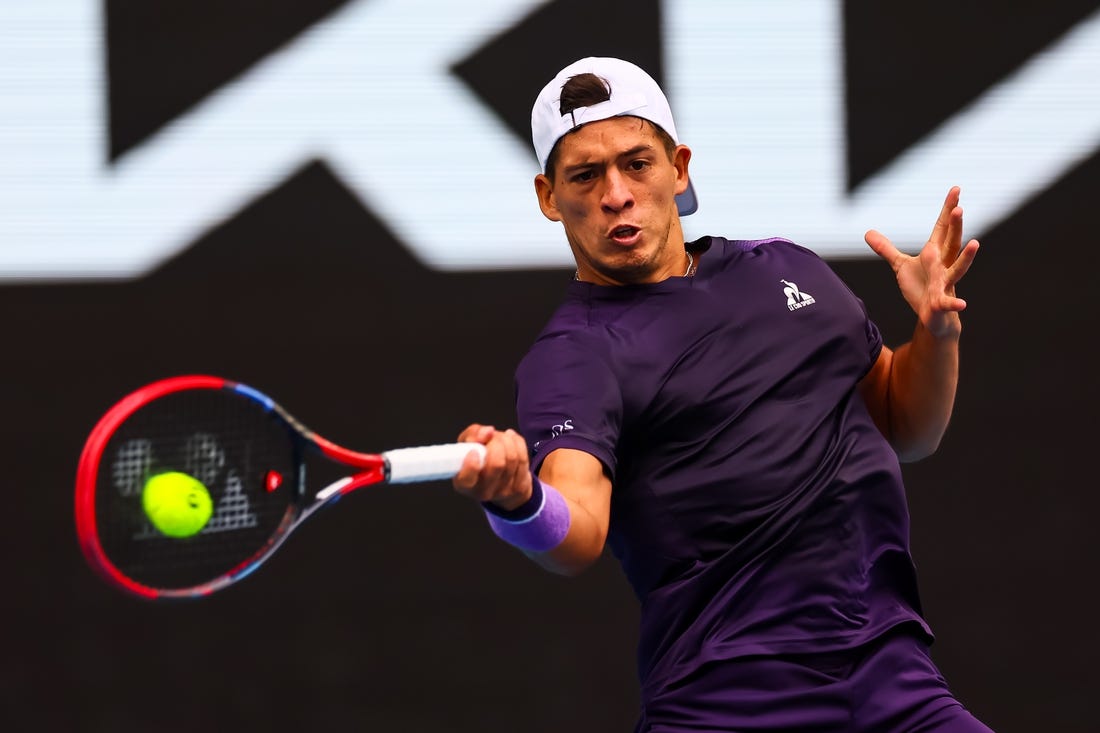 Jan 19, 2024; Melbourne, Victoria, Australia; Sebastian Baez of Argentina plays a shot against Jannik Sinner (not pictured) of Italy in Round 3 of the Men's Singles on Day 6 of the Australian Open tennis at Margaret Court Arena. Mandatory Credit: Mike Frey-USA TODAY Sports