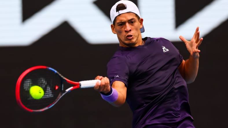 Jan 19, 2024; Melbourne, Victoria, Australia; Sebastian Baez of Argentina plays a shot against Jannik Sinner (not pictured) of Italy in Round 3 of the Men's Singles on Day 6 of the Australian Open tennis at Margaret Court Arena. Mandatory Credit: Mike Frey-USA TODAY Sports