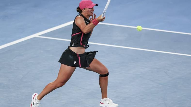 Jan 20, 2024; Melbourne, Victoria, Australia; Iga Swiatek of Poland plays a shot against Linda Noskova (not pictured) of Czechia in Round 3 of the Women's Singles on Day 7 of the Australian Open tennis at Rod Laver Arena. Mandatory Credit: Mike Frey-USA TODAY Sports