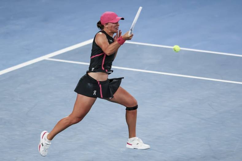 Jan 20, 2024; Melbourne, Victoria, Australia; Iga Swiatek of Poland plays a shot against Linda Noskova (not pictured) of Czechia in Round 3 of the Women's Singles on Day 7 of the Australian Open tennis at Rod Laver Arena. Mandatory Credit: Mike Frey-USA TODAY Sports