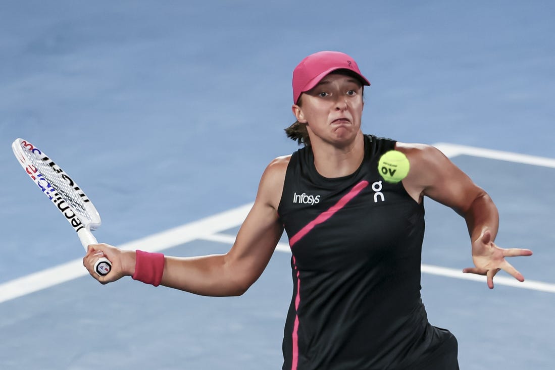 Jan 20, 2024; Melbourne, Victoria, Australia; Iga Swiatek of Poland plays a shot against Linda Noskova (not pictured) of Czechia in Round 3 of the Women's Singles on Day 7 of the Australian Open tennis at Rod Laver Arena. Mandatory Credit: Mike Frey-USA TODAY Sports