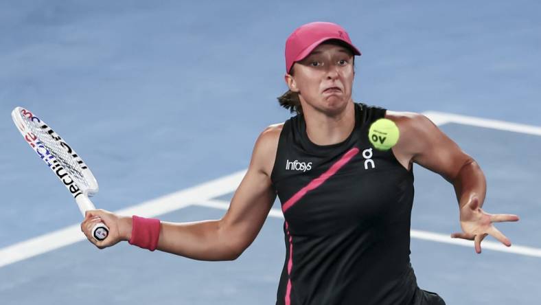 Jan 20, 2024; Melbourne, Victoria, Australia; Iga Swiatek of Poland plays a shot against Linda Noskova (not pictured) of Czechia in Round 3 of the Women's Singles on Day 7 of the Australian Open tennis at Rod Laver Arena. Mandatory Credit: Mike Frey-USA TODAY Sports