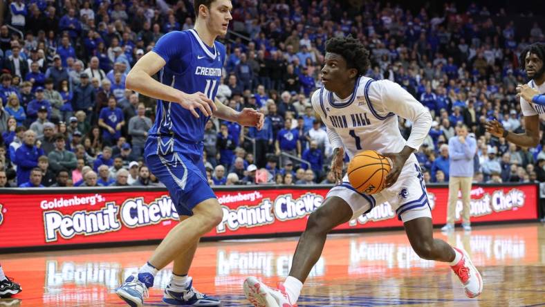 Jan 20, 2024; Newark, New Jersey, USA; Seton Hall Pirates guard Kadary Richmond (1) drives to the basket against Creighton Bluejays center Ryan Kalkbrenner (11) during double overtime at Prudential Center. Mandatory Credit: Vincent Carchietta-USA TODAY Sports