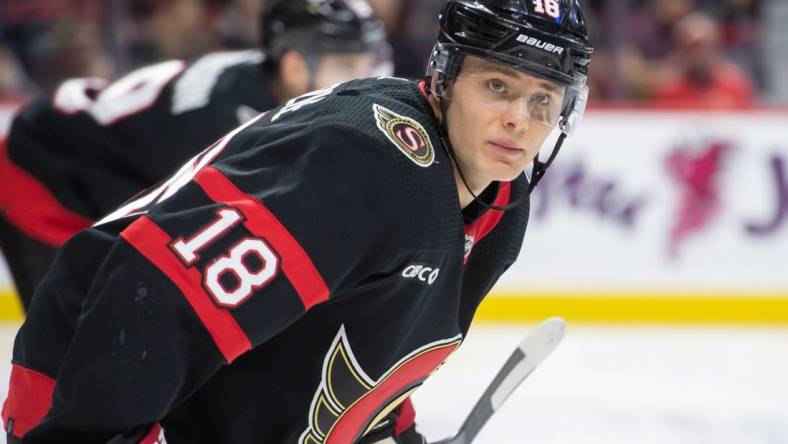 Jan 20, 2024; Ottawa, Ontario, CAN; Ottawa Senators center Tim Stutzle (18) lines up for a faceoff in the second period against the Winnipeg Jets at the Canadian Tire Centre. Mandatory Credit: Marc DesRosiers-USA TODAY Sports