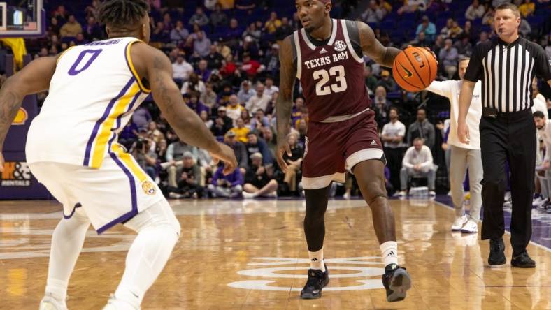 Jan 20, 2024; Baton Rouge, Louisiana, USA;  Texas A&M Aggies guard Tyrece Radford (23) dribbles against LSU Tigers guard Trae Hannibal (0) during the second half at Pete Maravich Assembly Center. Mandatory Credit: Stephen Lew-USA TODAY Sports