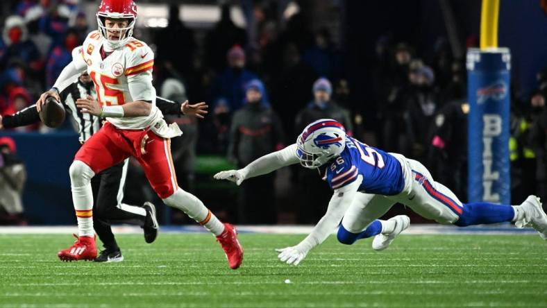 Jan 21, 2024; Orchard Park, New York, USA; Kansas City Chiefs quarterback Patrick Mahomes (15) rushes the ball past Buffalo Bills defensive end Leonard Floyd (56) in the second half of the 2024 AFC divisional round game at Highmark Stadium. Mandatory Credit: Mark Konezny-USA TODAY Sports