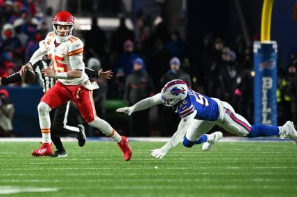 Jan 21, 2024; Orchard Park, New York, USA; Kansas City Chiefs quarterback Patrick Mahomes (15) rushes the ball past Buffalo Bills defensive end Leonard Floyd (56) in the second half of the 2024 AFC divisional round game at Highmark Stadium. Mandatory Credit: Mark Konezny-USA TODAY Sports