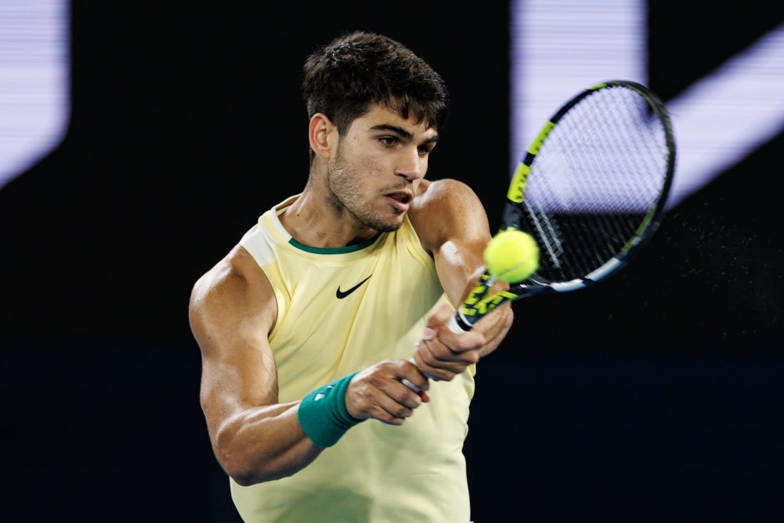 Jan 24, 2024; Melbourne, Victoria, Australia; 
Carlos Alcaraz of Spain in action against Alexander Zverev of Germany in the quarter final of the men s singles at the Australian Open. Mandatory Credit: Mike Frey-USA TODAY Sports