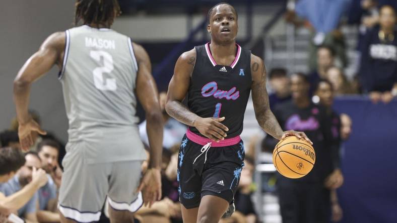 Jan 24, 2024; Houston, Texas, USA; Florida Atlantic Owls guard Johnell Davis (1) brings the ball up the court as Rice Owls guard Mekhi Mason (2) defends during the first half at Tudor Fieldhouse. Mandatory Credit: Troy Taormina-USA TODAY Sports