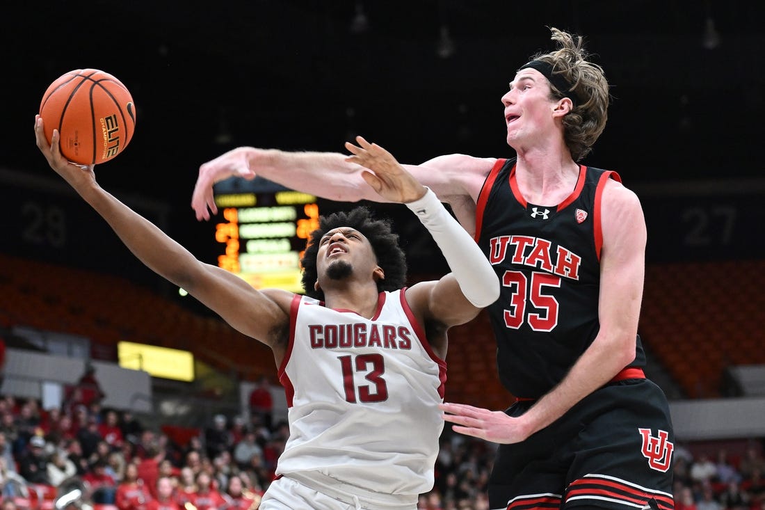 Jan 24, 2024; Pullman, Washington, USA; Washington State Cougars forward Isaac Jones (13) shoots the ball against Utah Utes center Branden Carlson (35) in the second half at Friel Court at Beasley Coliseum. Washington State won 79-57. Mandatory Credit: James Snook-USA TODAY Sports