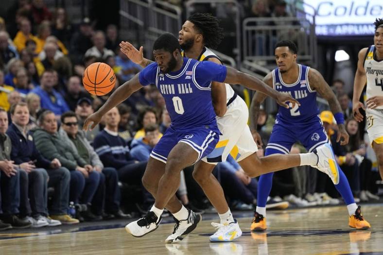 Jan 27, 2024; Milwaukee, Wisconsin, USA;  Seton Hall Pirates guard Dylan Addae-Wusu (0) and Marquette Golden Eagles forward David Joplin (23) chase the loose ball during the second half at Fiserv Forum. Mandatory Credit: Jeff Hanisch-USA TODAY Sports