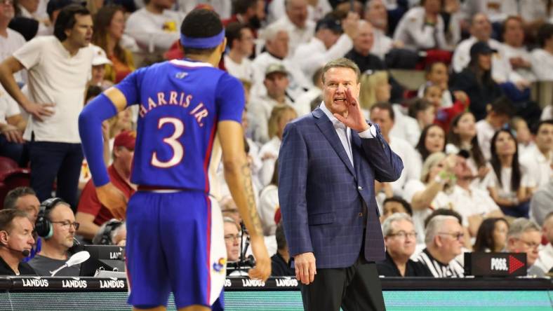 Feb 4, 2023; Ames, Iowa, USA;  Kansas Jayhawks head coach Bill Self talks with guard Dajuan Harris Jr. (3) during a game against the Iowa State Cyclones at James H. Hilton Coliseum. Mandatory Credit: Reese Strickland-USA TODAY Sports