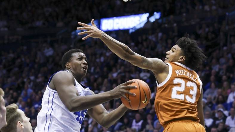 Jan 27, 2024; Provo, Utah, USA; Brigham Young Cougars forward Fousseyni Traore (45) drives to the basket against Texas Longhorns forward Dillon Mitchell (23) during the second half at Marriott Center. Mandatory Credit: Rob Gray-USA TODAY Sports