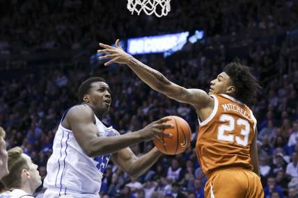 Jan 27, 2024; Provo, Utah, USA; Brigham Young Cougars forward Fousseyni Traore (45) drives to the basket against Texas Longhorns forward Dillon Mitchell (23) during the second half at Marriott Center. Mandatory Credit: Rob Gray-USA TODAY Sports