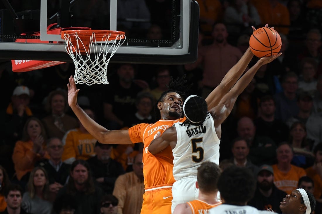 Jan 27, 2024; Nashville, Tennessee, USA; Tennessee Volunteers forward Jonas Aidoo (0) blocks a shot attempt by Vanderbilt Commodores guard Ezra Manjon (5) during the second half at Memorial Gymnasium. Mandatory Credit: Christopher Hanewinckel-USA TODAY Sports