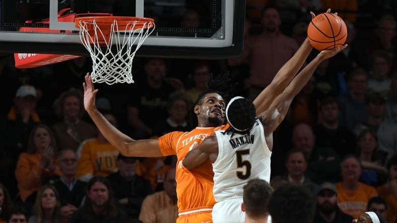 Jan 27, 2024; Nashville, Tennessee, USA; Tennessee Volunteers forward Jonas Aidoo (0) blocks a shot attempt by Vanderbilt Commodores guard Ezra Manjon (5) during the second half at Memorial Gymnasium. Mandatory Credit: Christopher Hanewinckel-USA TODAY Sports