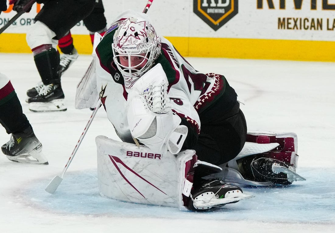 Jan 27, 2024; Raleigh, North Carolina, USA; Arizona Coyotes goaltender Connor Ingram (39) makes a glove save against the Carolina Hurricanes during the third period at PNC Arena. Mandatory Credit: James Guillory-USA TODAY Sports