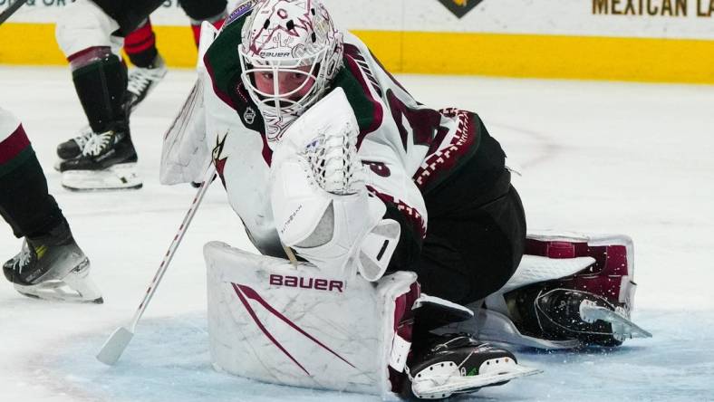 Jan 27, 2024; Raleigh, North Carolina, USA; Arizona Coyotes goaltender Connor Ingram (39) makes a glove save against the Carolina Hurricanes during the third period at PNC Arena. Mandatory Credit: James Guillory-USA TODAY Sports