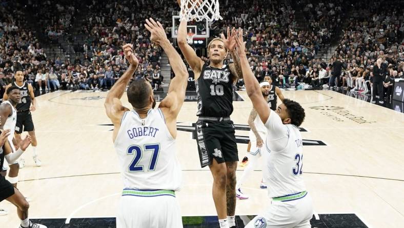 Jan 27, 2024; San Antonio, Texas, USA; San Antonio Spurs forward Jeremy Sochan (10) drives to the basket past Minnesota Timberwolves centers Rudy Gobert (27) and Karl-Anthony Towns (32) during the second half at Frost Bank Center. Mandatory Credit: Scott Wachter-USA TODAY Sports