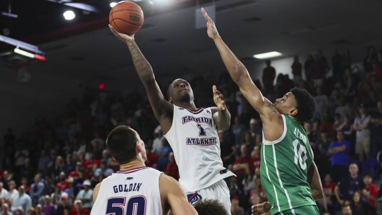 Jan 28, 2024; Boca Raton, Florida, USA; Florida Atlantic Owls guard Johnell Davis (1) shoots the basketball over North Texas Mean Green forward Robert Allen (10) during the second half at Eleanor R. Baldwin Arena. Mandatory Credit: Sam Navarro-USA TODAY Sports