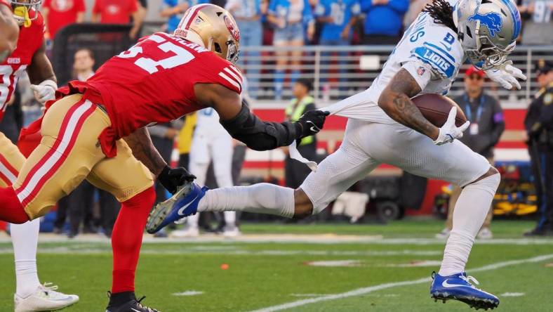 Jan 28, 2024; Santa Clara, California, USA; Detroit Lions wide receiver Jameson Williams (9) runs with the ball for a touchdown San Francisco 49ers linebacker Dre Greenlaw (57) during the first half of the NFC Championship football game at Levi's Stadium. Mandatory Credit: Kelley L Cox-USA TODAY Sports