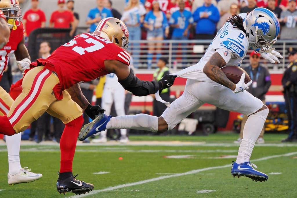 Jan 28, 2024; Santa Clara, California, USA; Detroit Lions wide receiver Jameson Williams (9) runs with the ball for a touchdown San Francisco 49ers linebacker Dre Greenlaw (57) during the first half of the NFC Championship football game at Levi's Stadium. Mandatory Credit: Kelley L Cox-USA TODAY Sports