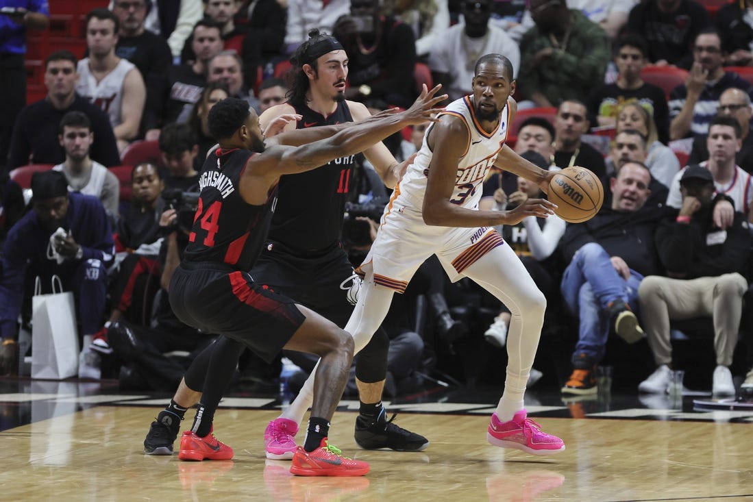 Jan 29, 2024; Miami, Florida, USA; Phoenix Suns forward Kevin Durant (35) protects the basketball from Miami Heat forward Haywood Highsmith (24) and guard Jaime Jaquez Jr. (11) during the third quarter at Kaseya Center. Mandatory Credit: Sam Navarro-USA TODAY Sports